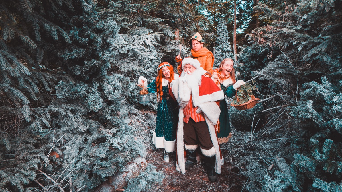 Father Christmas and the residents walking together through the forest