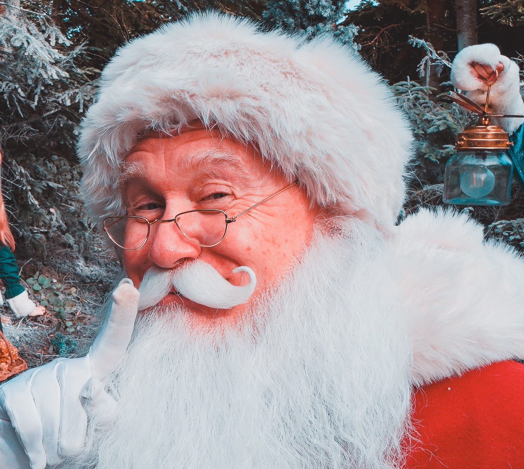 Father Christmas smiling with his lantern