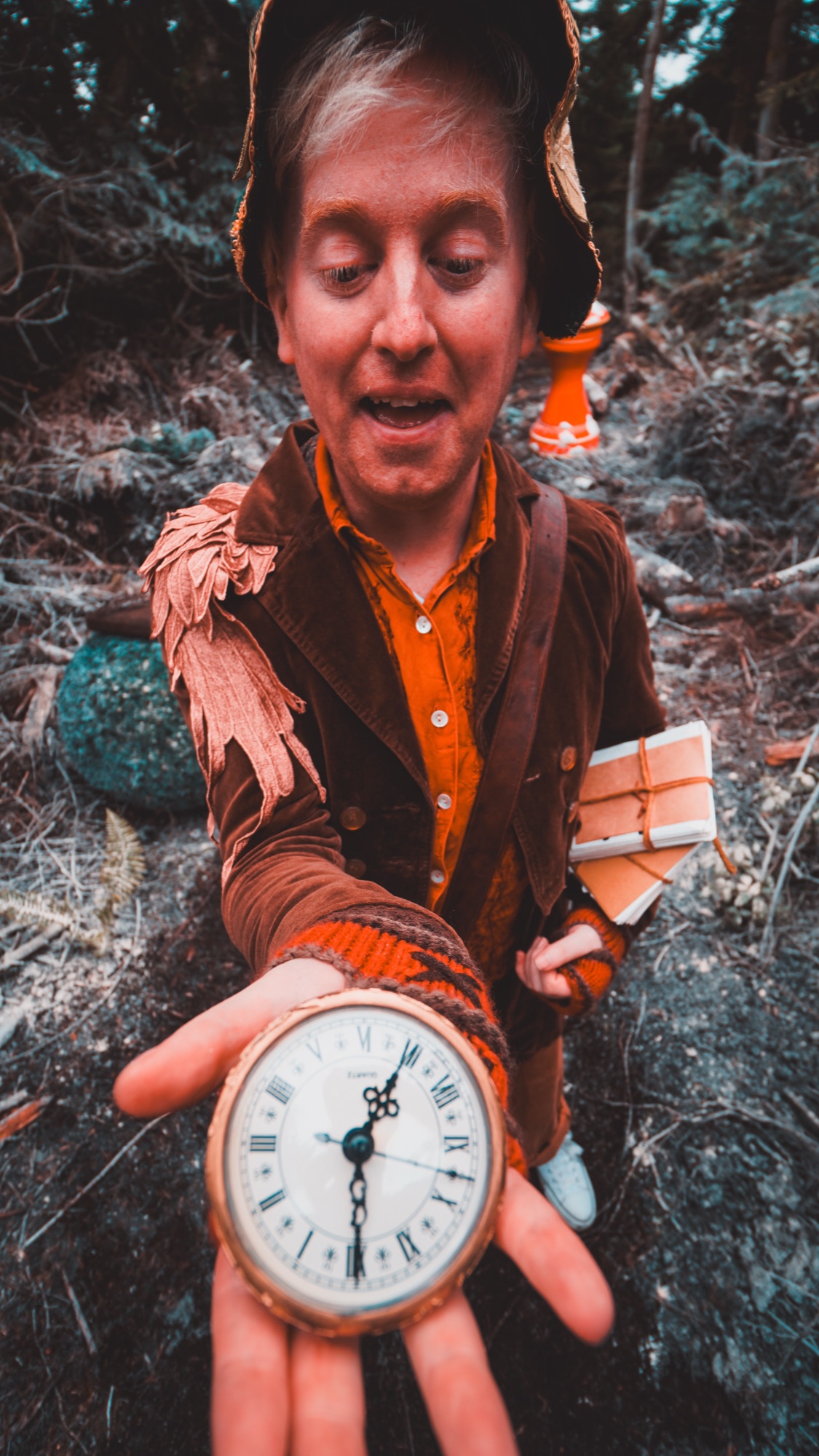 Nollaig holding his pocket watch in the frosted forest